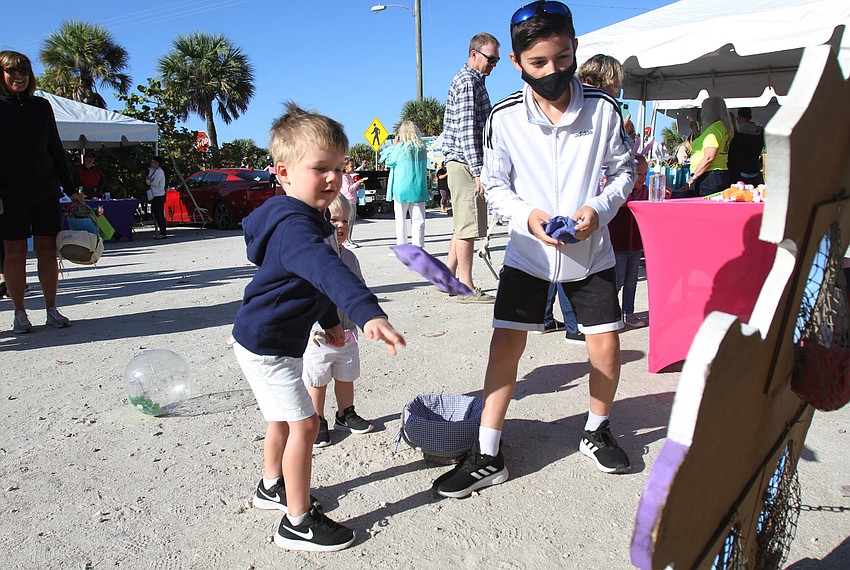 David Weber plays the bean bag toss game.