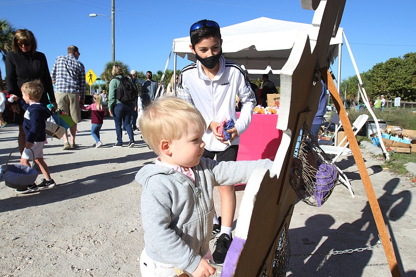 Ethan Weber plays the bean bag toss game.
