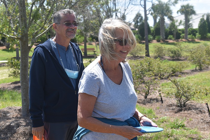 Indigo residents Cecilio and Chantal Echeandia laugh about a shot that barely missed the basket. They were on the same team for the first hole of 