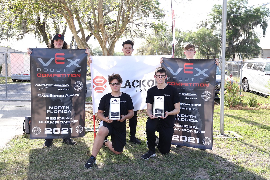 Students Quinn Coomer, Rafael Treminio Bravo,  Seth Johnson, Armand Segui and Cannon Spencer are all smiles after winning the VEX Robotics state championship.