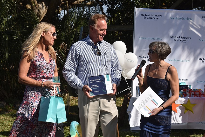 Janet and Steve Walter accept an award from Sharon Gould.