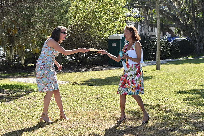 Laura Bowers hands Sherry Dominick an award.