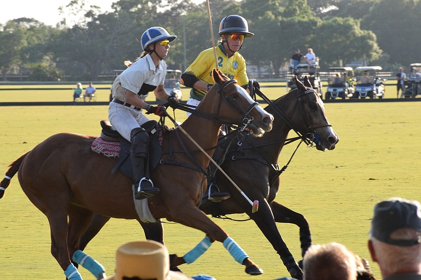 Investus' Camille Ricaud races for the ball alongside Whiskey Pond's Neil Osburg.
