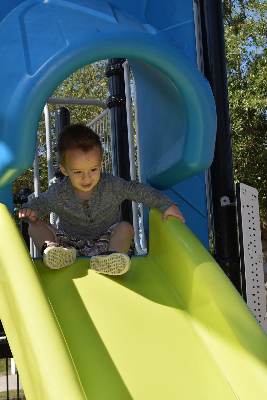 Harmony's Jack Hall, who is 20 months old, gets ready to go down the slide.