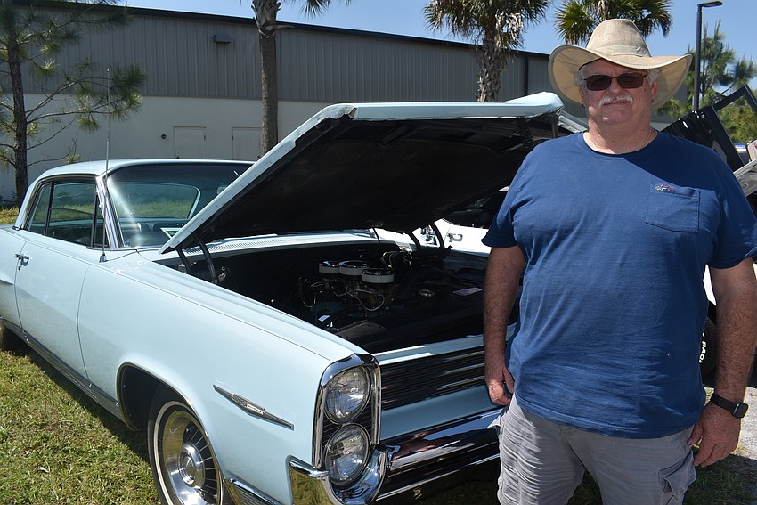Bradenton resident Darwin Heinzman stands with his 1964 Pontiac Bonneville, which he called a 
