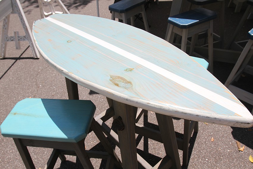 Coastal Flow Furniture and Decor sold painted surfboard tables.