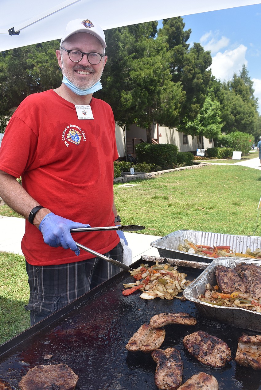 Edgewater Cove resident and Knights of Columbus member Tom Williams mans the grill. He said sausage and peppers were the most popular item of the day.