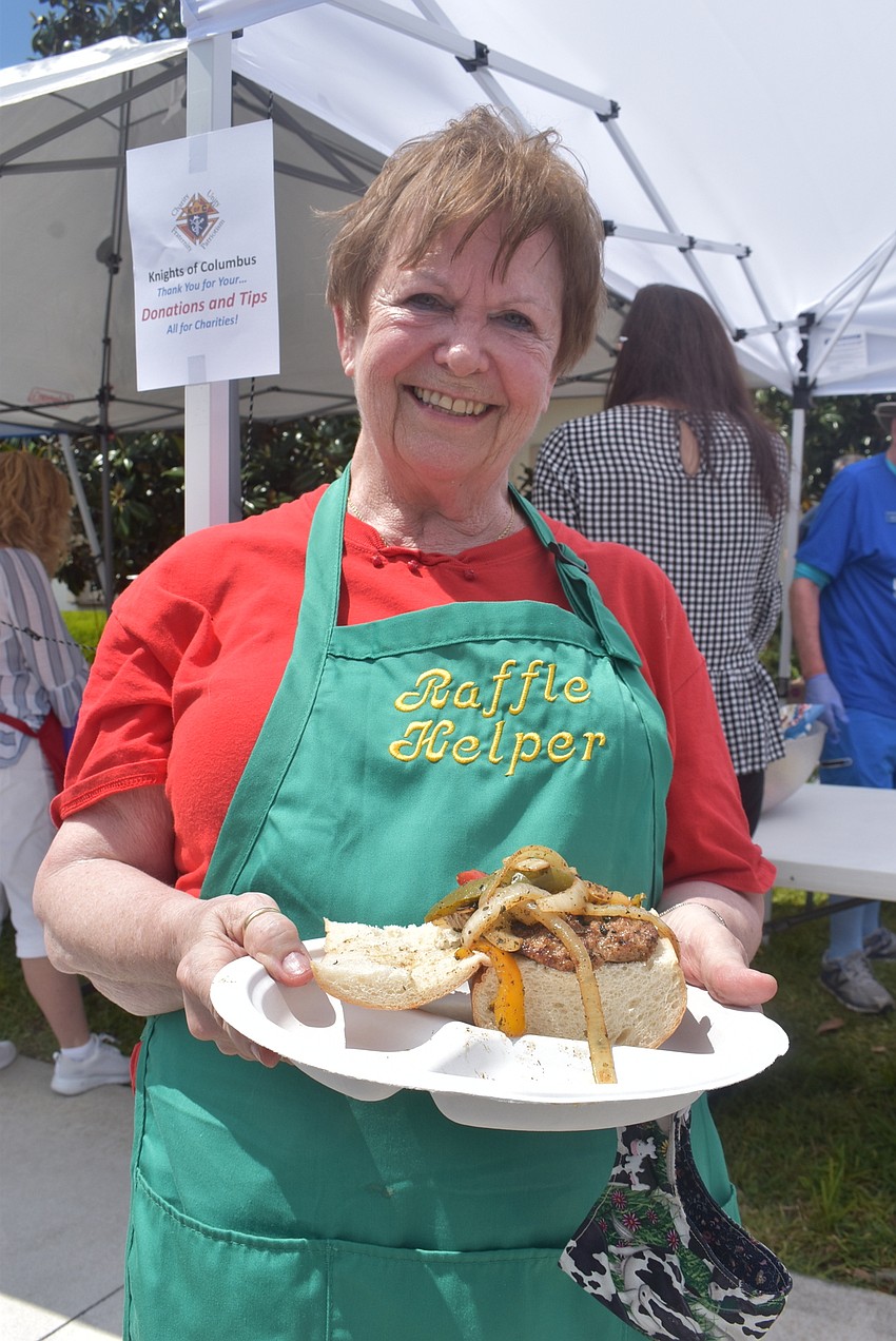 Donna Makovec of the St. Clare Women's Guild shows off her sausage and pepper sandwich. Makovec said the second edition of the craft fair was successful enough that the guild is planning a third one for December.