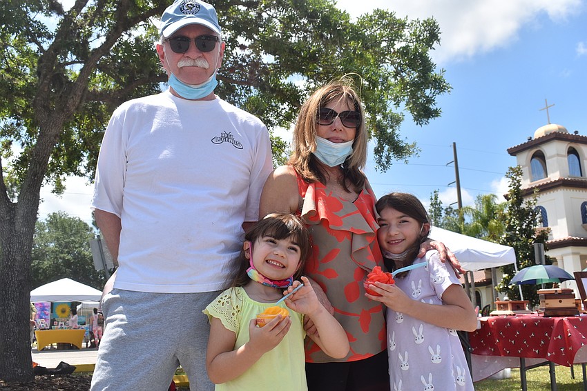 Summerfield residents Carl Perhac, Linda Perhac, Elise Perhac, 5, and Ava Perhac, 6, smile after a visit to Carousel's Soft Serve Icery truck. Elise Perhac tried mango, while Ava Perhac tried cherry.