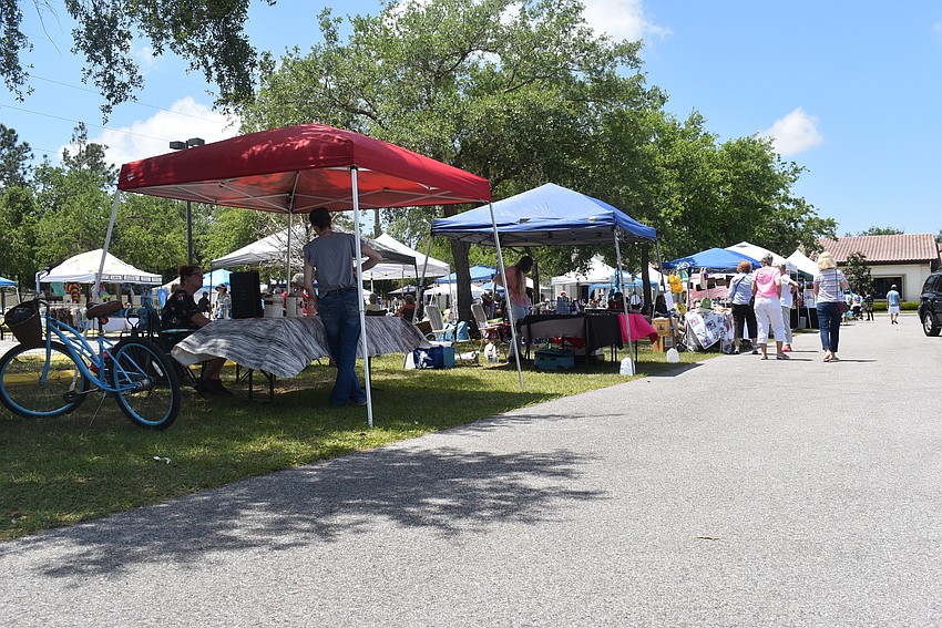 Vendors line the parking lot at Our Lady of the Angels Catholic Church for the Arts and Crafts Market, held by St. Clare Women's Guild. The guild is planning another market for December.