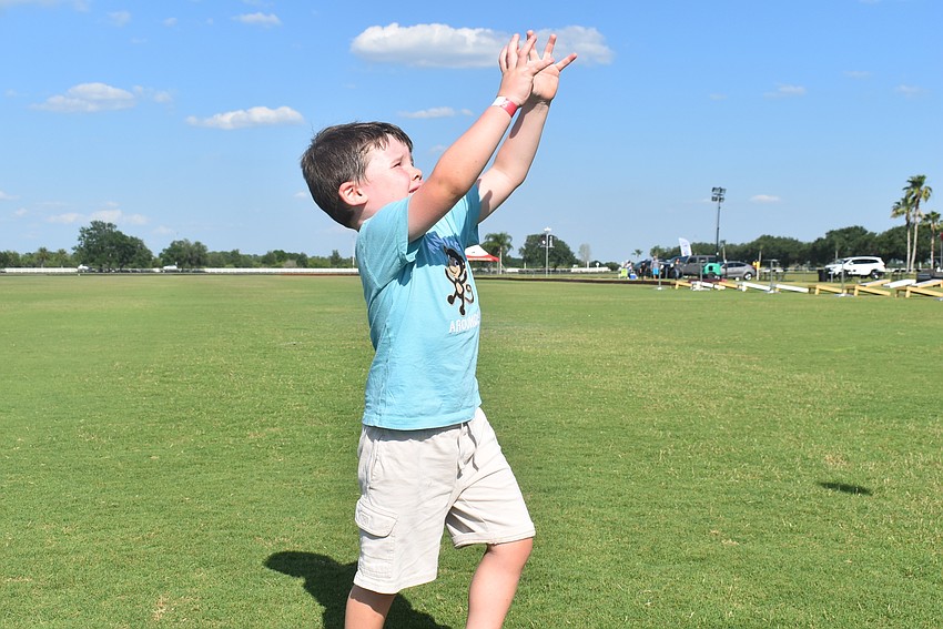 Greenbrook resident Maverick Chafin, 4, prepares to catch a football. He said his favorite sport is soccer because he loves to kick the ball and score a lot of goals.