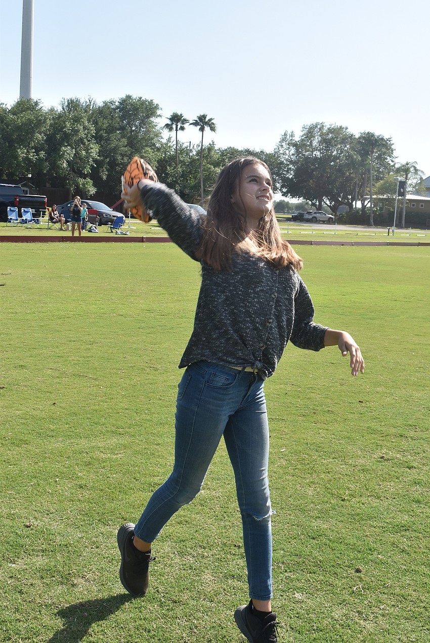 Greenbrook resident Elena Viteri, 13, throws a football to her brother, Alex Viteri. Elena said she loves sports, especially softball, where she enjoys playing every position on the field.