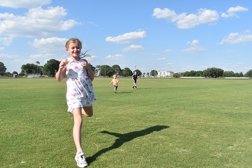 Lakewood Ranch resident Emily Chana, 6, chases down a Frisbee thrown by her friend, 6-year-old Harley Hendrix. Hendrix was proud of his ability to throw the Frisbee far, more than 100 feet on several occasions.