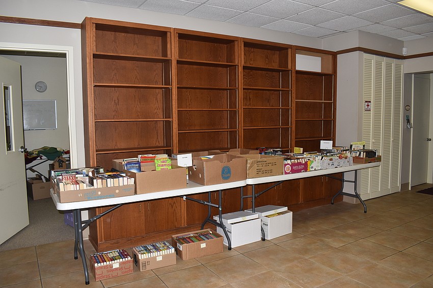 The shelves were emptied onto tables in front of them.