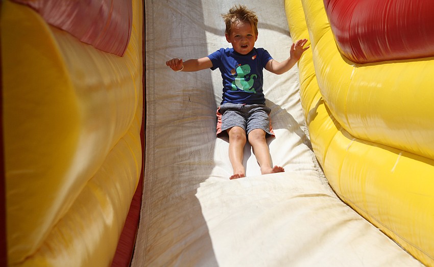 Carter Stine slides down the slide.
