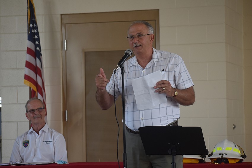 East Manatee Fire Rescue District Commissioner Bob Conley watches former East Manatee Fire Rescue District Chief Byron Teates speak about Don O'Leary at the grand opening of East Manatee Fire Station 8.