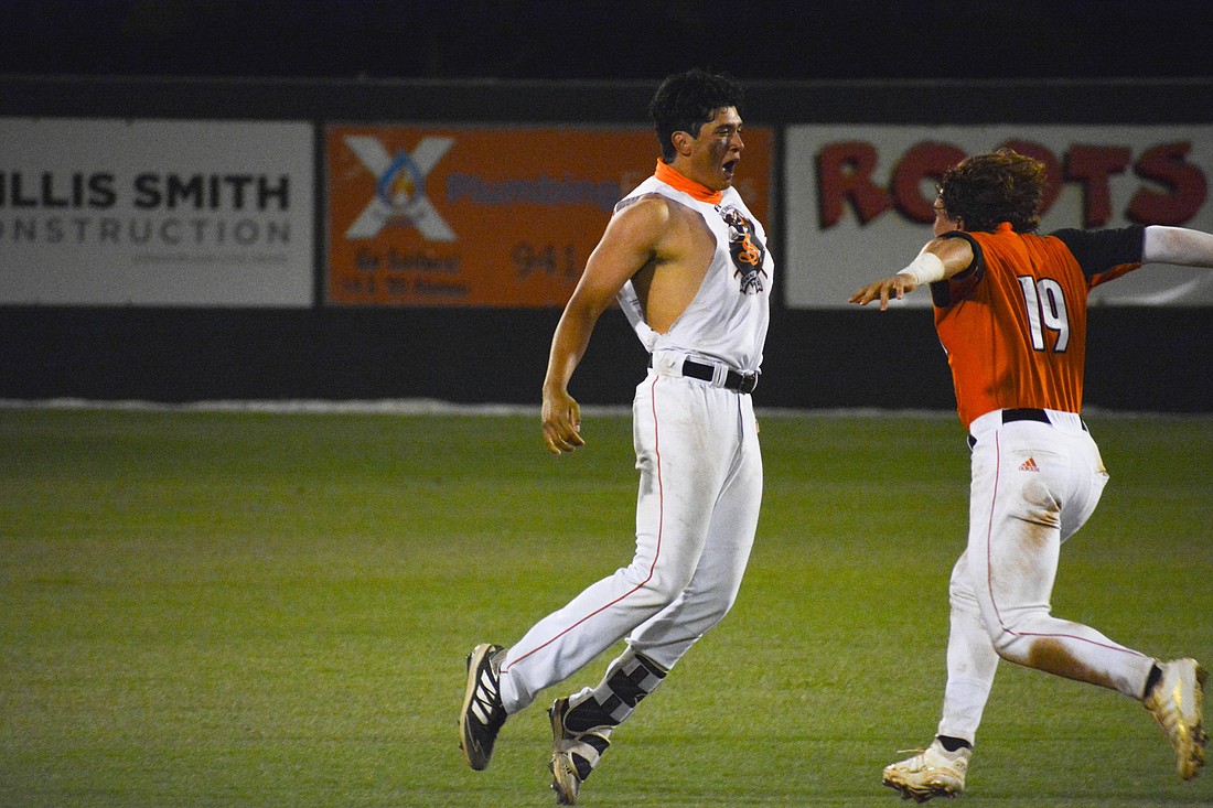 Danny Torrealba and Satchell Norman celebrate after the Sailors&#39; win against Lakewood Ranch.