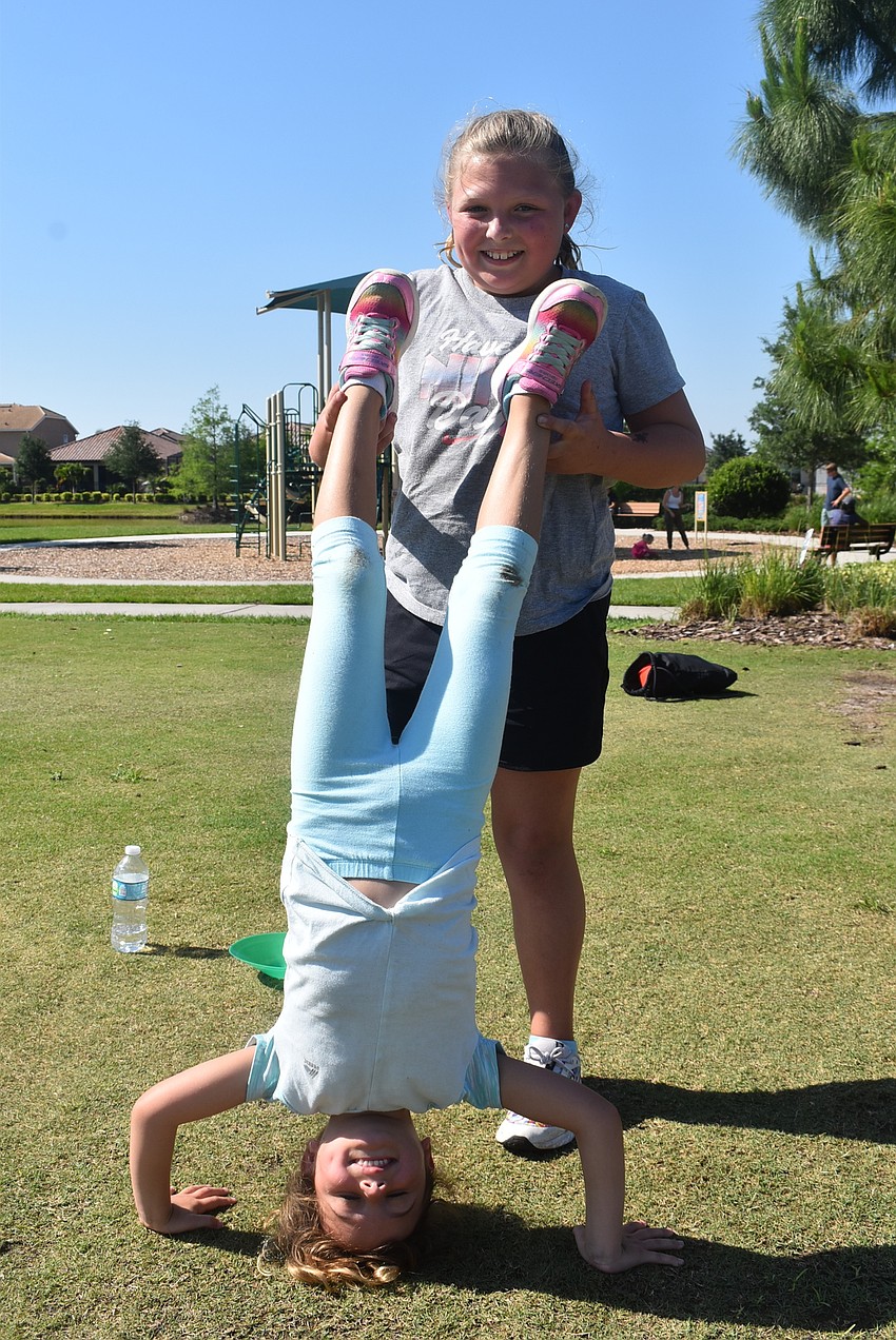 Greenbrook resident Nahla Vlasak holds her friend and neighbor, Nora Clementi, in between drills.