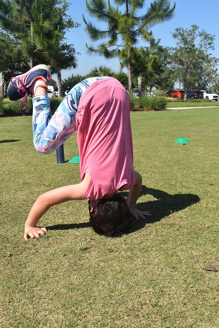 Indigo resident Scarlett Walsh, 7, does a somersault in between drills at Fit4Kids. Walsh enjoyed volunteering to demonstrate different types of push-ups for her peers, such as regular and diamond style.