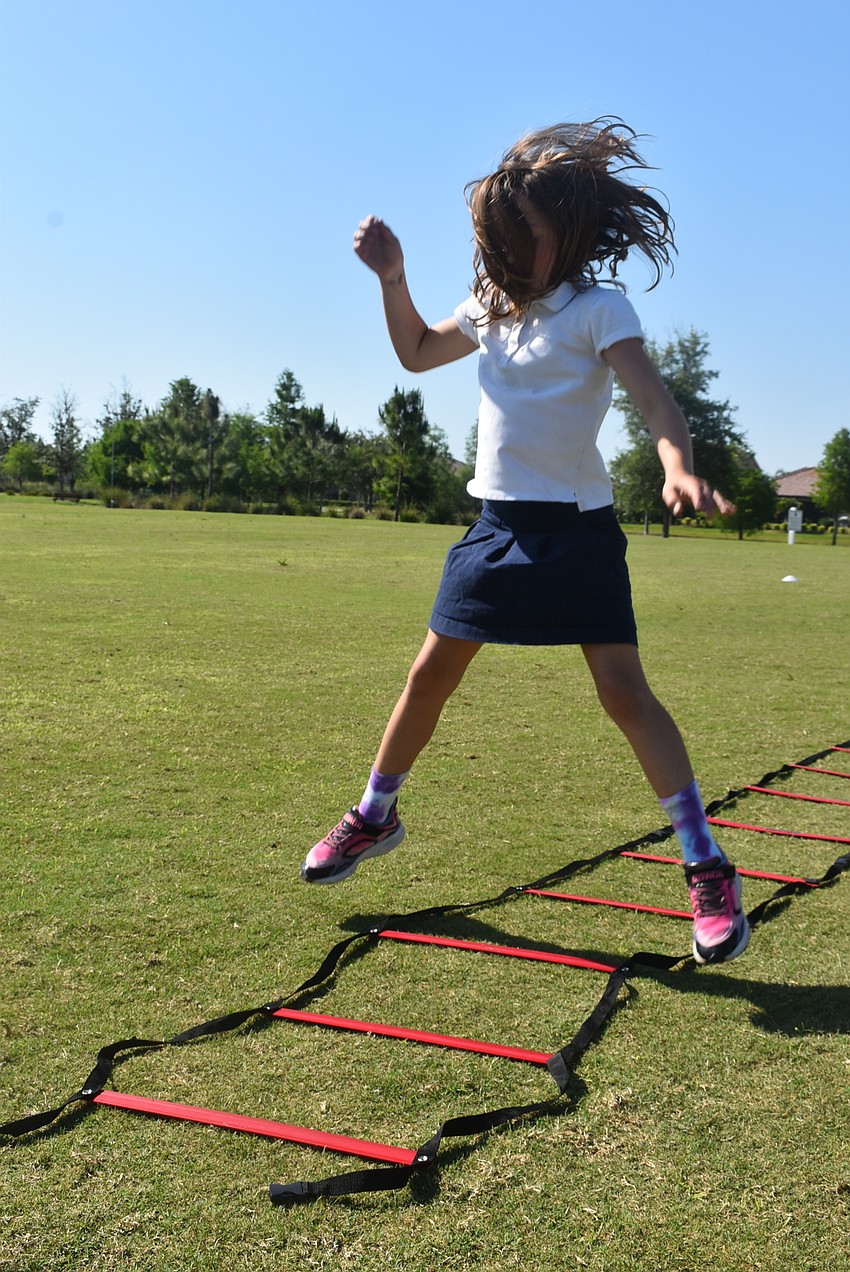 Greenbrook resident Ava Clementi, 8, jumps her way through ladder drills. Clementi was one of the fastest runners at Fit4Kids despite participating for the first time. She says she does a lot of running for gymnastics.