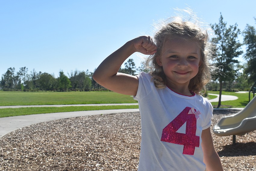 Lakewood Ranch resident Ella Volpe, 4, flexes after finishing Fit4Kids for the day. 