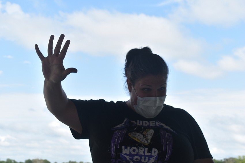 Acting coach Alyssa Goudy, who works for The Players Centre for Performing Arts, signals that she wants her students to repeat 