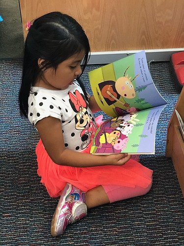 A student from Blanche H. Daughtrey Elementary School reads a book in Spanish. When students are in Spanish class, they will do everything in Spanish. When in English class, they&#39;ll read, speak and write in English. Courtesy photo