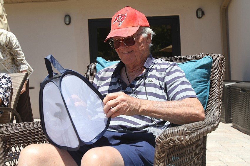 Sid Fleming holds a butterfly carrier.