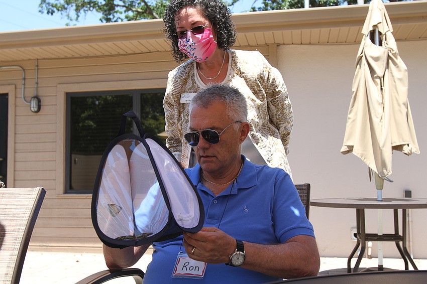 Lily Curry and Ron Wilson check out a butterfly carrier.