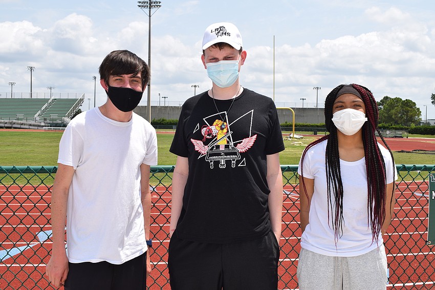 Junior Brandon Mikula, senior Zachary Miller and freshman Tremiryah Miller have fun at the band picnic.