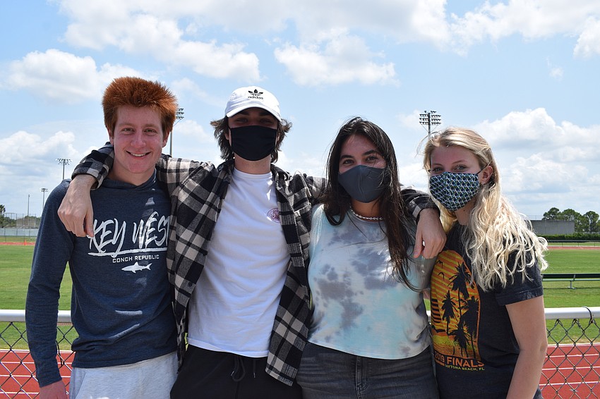 Eric Miller and Ethan Horn, who both graduated in 2020, visit senior Gianna Hagopian with 2020 graduate Madi McCoy. Alumni of the band attended to support the seniors and members of next year's band.