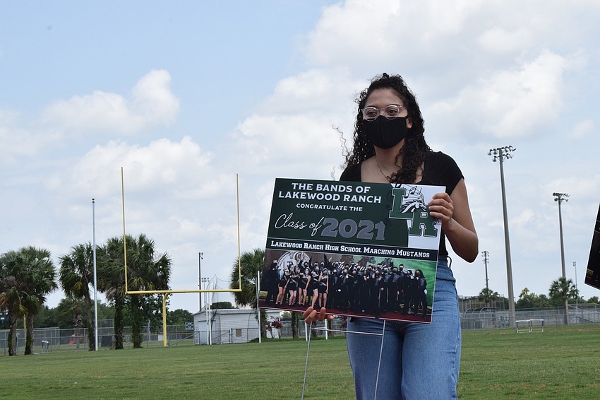 Senior Victoria Pugh takes home a yard sign honoring her final year with the band.