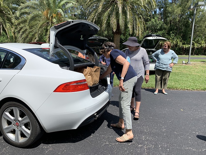 Karen Gary begins to unload a car.