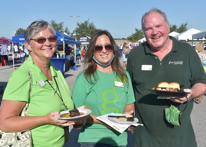 Grow Financial Relationship Specialists Lisa Griffin and Heather Mong and Area Manager Tom Cofer show off their food. Griffin and Mong said their favorites were bread pudding and bangers and mash from McGrath's Irish Ale House.