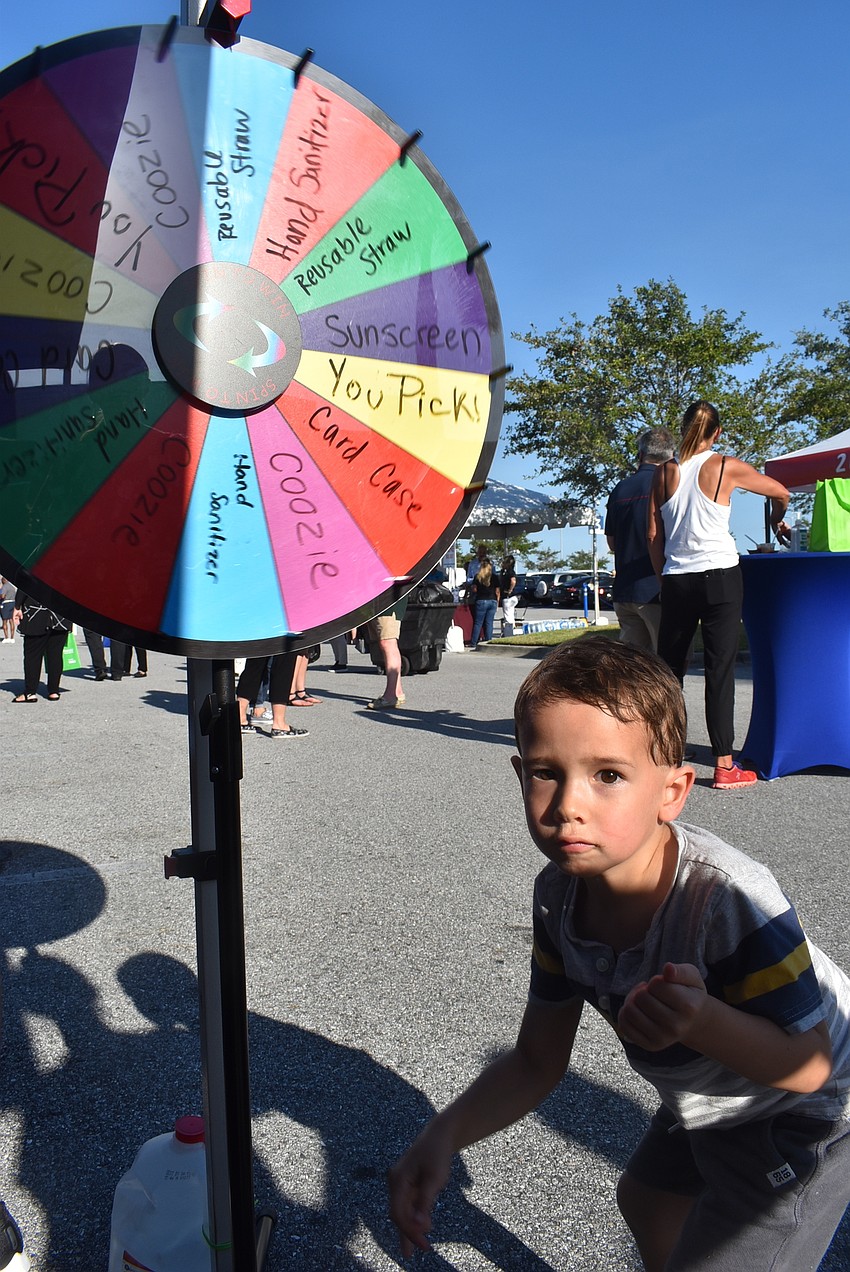 Sarasota's Emanuel Claxton, 3, spins a prize wheel. The wheel landed on 