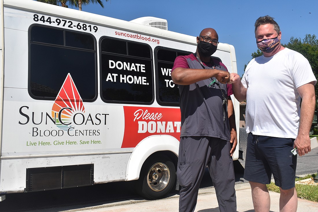 SunCoast Blood Centers Technician Ryan Milner and Parrish resident Daniel Wansten stand outside the mobile concierge unit. Milner and Wansten made an appointment to do it again the next day after Wansten&#39;s pulse came in over 100.