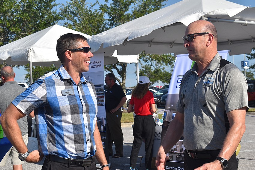 Spectrum Business Account Executive Brian Schmelzle and Custom ComTek Owner Bob McDonald, a Cypress Creek resident, have a conversation. McDonald said LWRBA events have helped him build valuable business connections.
