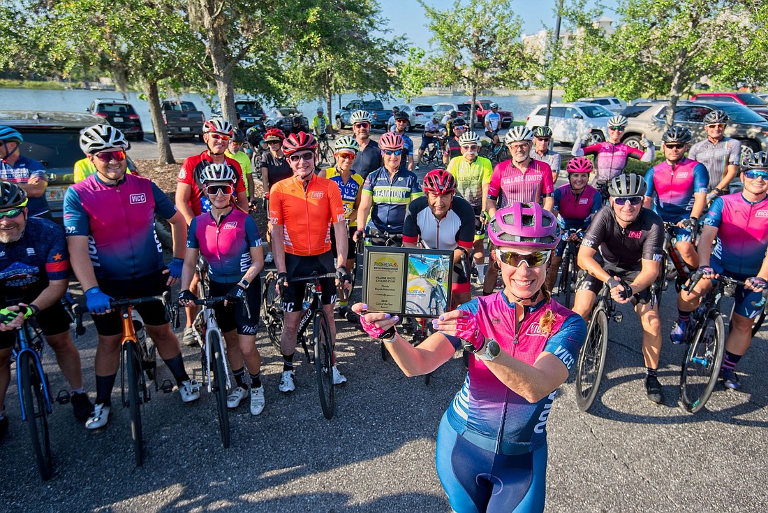 Club President Dawn Zielinski displays the Florida Bicycle Association Club of the Year award for 2020, which was won by the Village Idiots Cycling Club, based in Lakewood Ranch. (Photo courtesy of OdellPhotos.com)