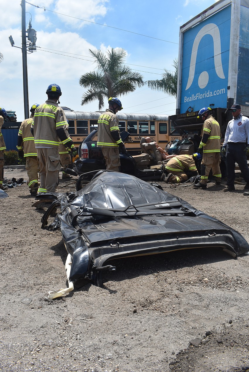 The top of the car sits after being detached from the rest of the vehicle during a drill to rescue passengers who were being crushed under the back of an 18-wheeler.