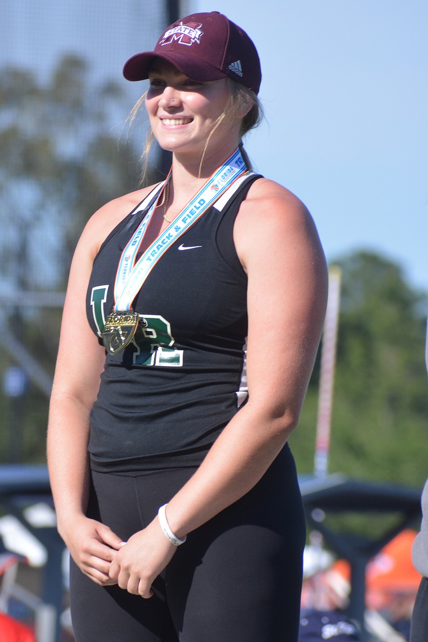 Lakewood Ranch senior Riley Simmons beams after receiving her gold medal for winning the Class 4A shot put (44 feet, 3.25 inches).