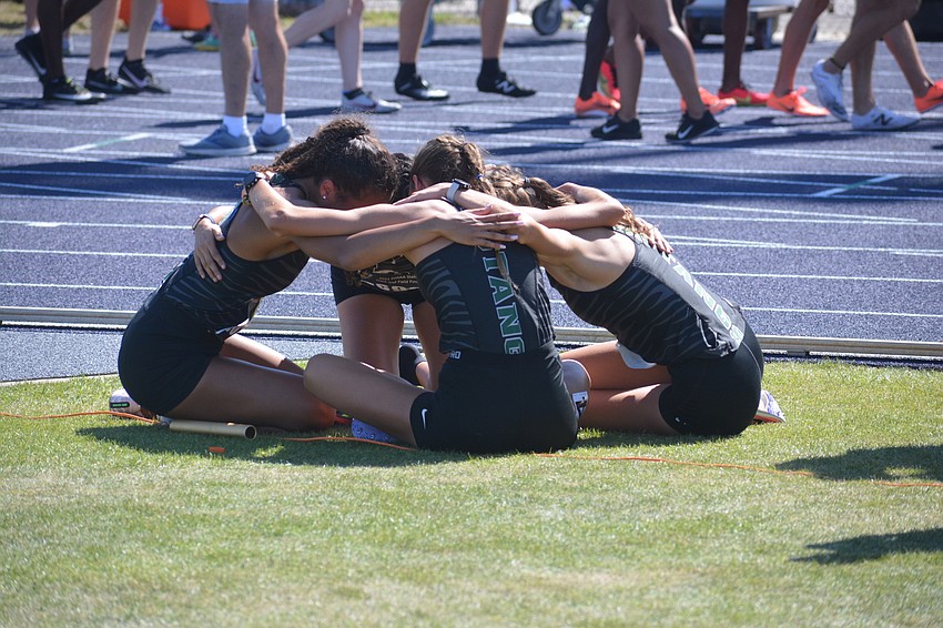 Lakewood Ranch juniors Ariana Majaro, Grace Marston, Maya Bridgeford and Hailey Marston embrace after finishing second in the girls Class 4A 4x800 relay (9:15.87).