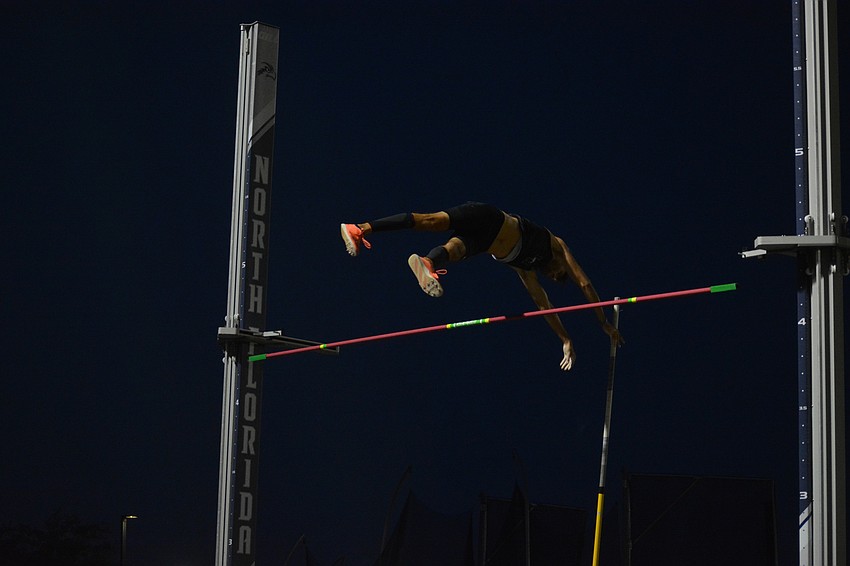 Lakewood Ranch senior Eli Newman soars over the pole vault bar against a darkened sky. Newman would finish tied for third in the Class 4A boys pole vault (14 feet, 3.25 inches).