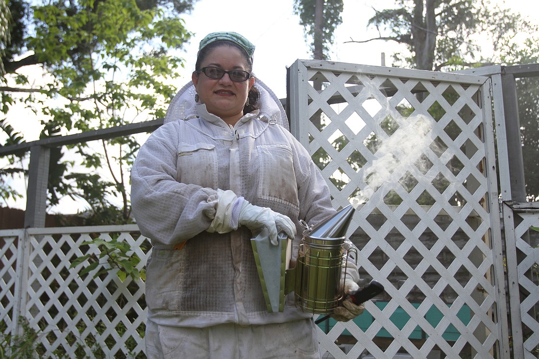 Alma Johnson works hard to nurture her queen bees and colonies.