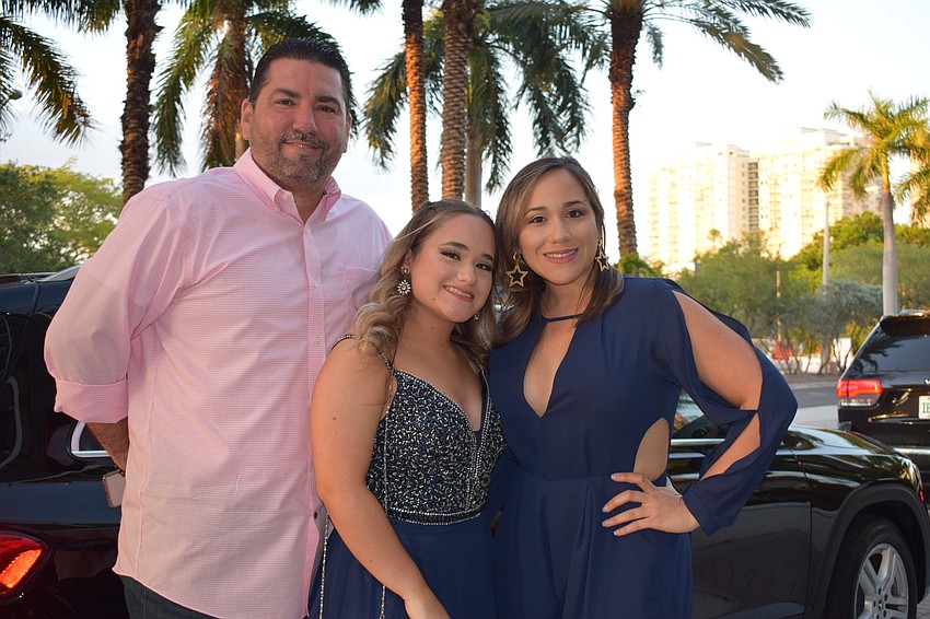 Eduardo Mirandra drops off Nemesis Rivera, a senior at Lakewood Ranch  High School, after her mother, Isis Sanchez takes photos of her to commemorate the prom.