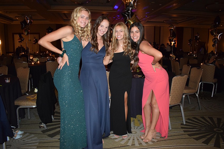 Seniors Julia Kuehn, Peyton Trent, AJ Sprague and Makenna Clarkin have fun hanging out with friends at prom without wearing masks. 
