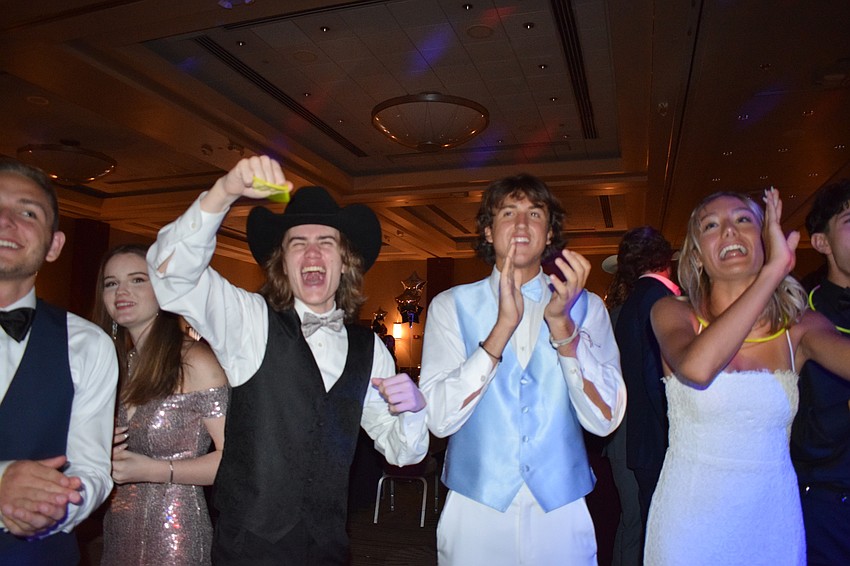 Seniors Matthew Donato, Jakin Wilson and Makena Murack cheer for Fallon Gehrke after she's announced as the prom queen.