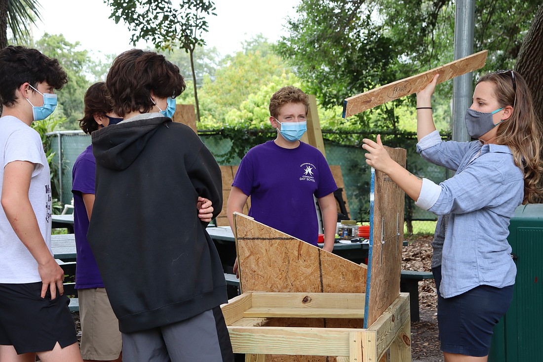 Agricultural Sciences teacher Meg Lea shows students how to piece the chicken coop together. Photo courtesy