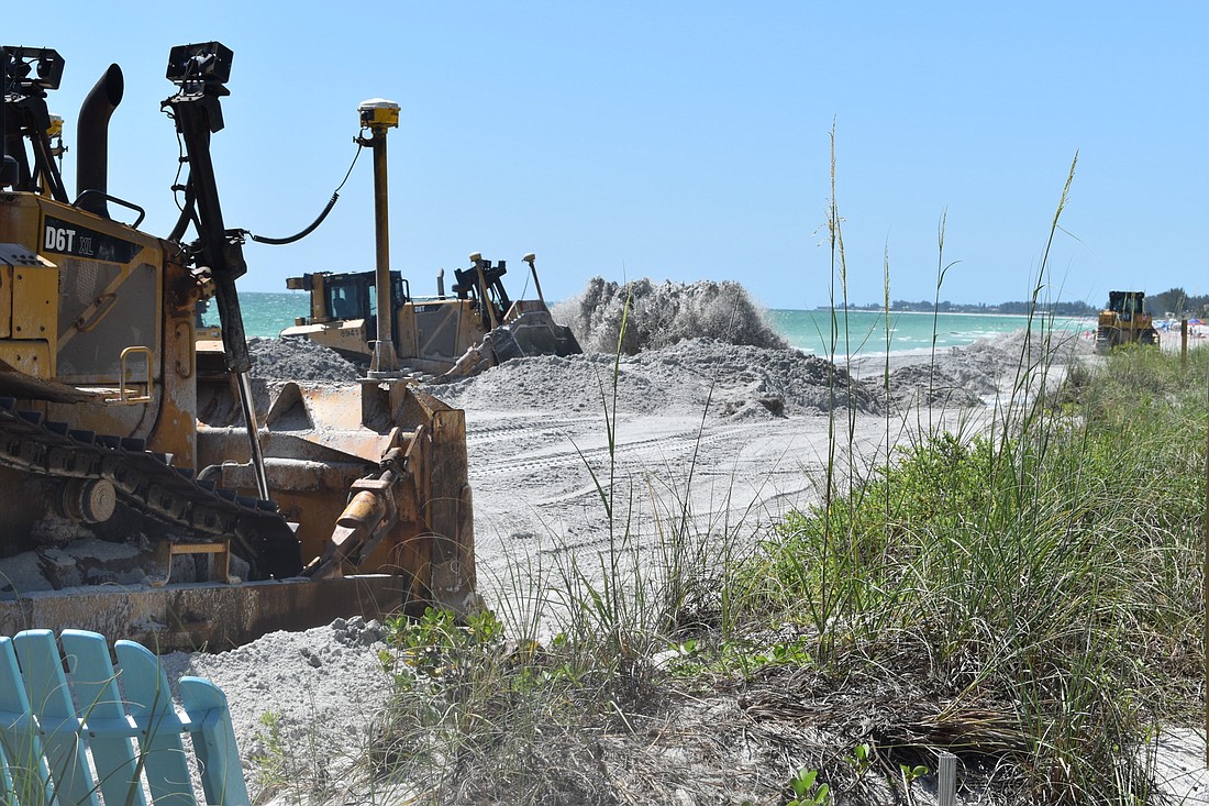 Workers contracted by the town of Longboat Key dredge sand on Friday, May 14 at 4001 Gulf of Mexico Drive.