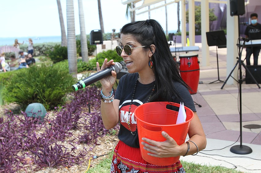 Alyssa Martin of the Music Compound welcomes on new students to play.