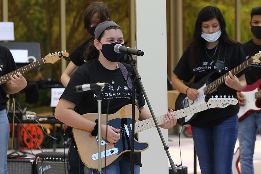 Alix Leinweber plays guitar for the crowd.